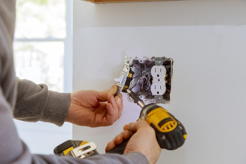 Work on installing electrical outlets with electrical wires and connector installed in plasterboard Northern Nevada